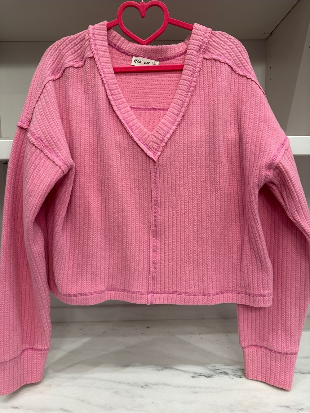 New In small pink ribbed v-neck sweater.  Like new